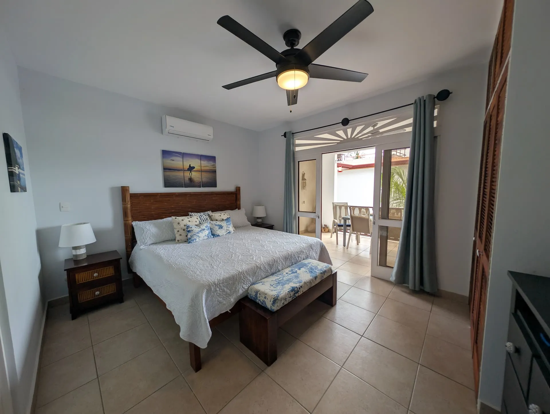 Primary bedroom with king bed and private terrace access.