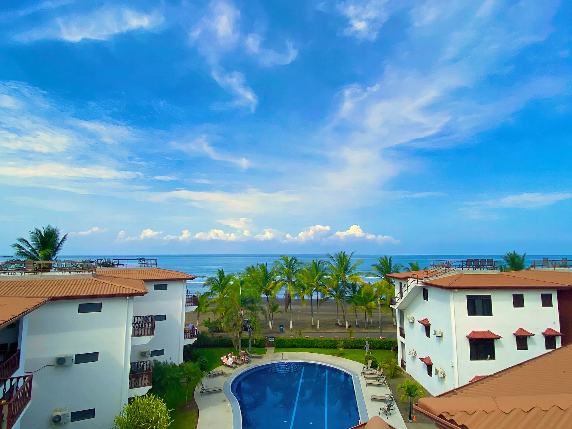 View from the rooftop terrace over the pool toward the ocean.